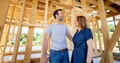 Couple walks around their new home build mid-construction