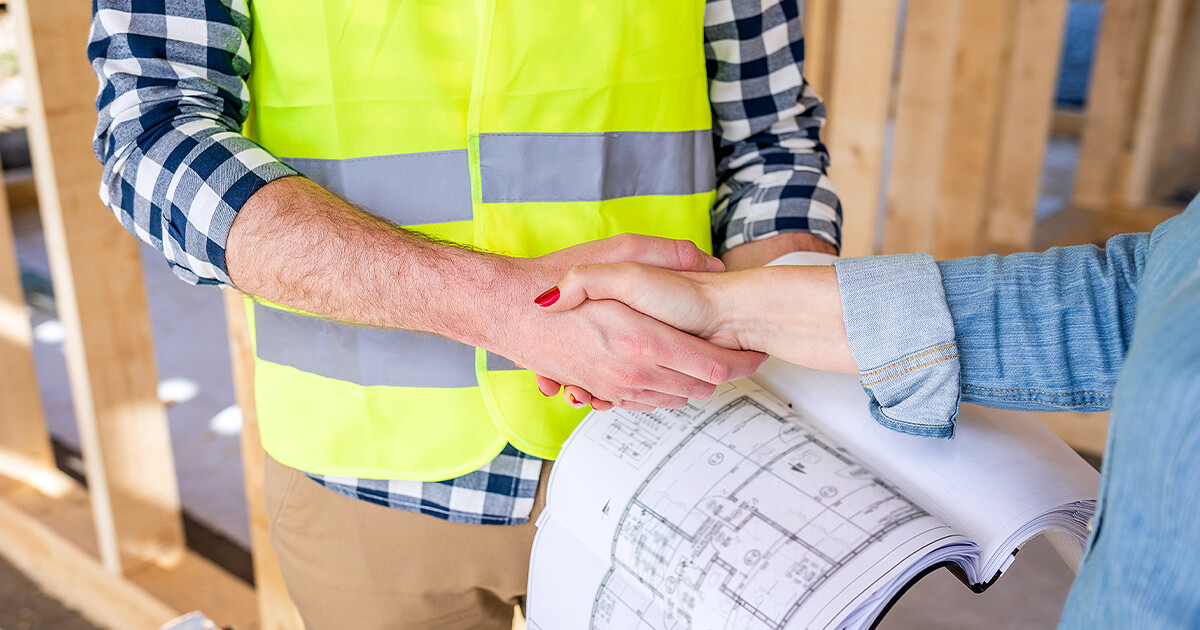 Female shakes hand with Bundaberg home builder on site