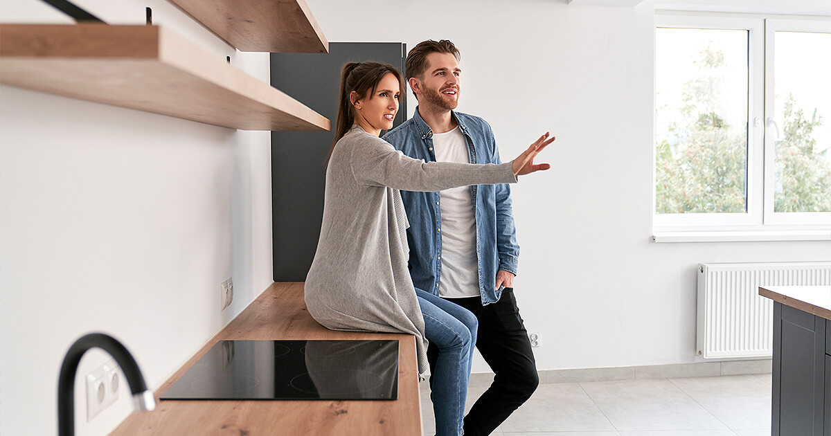 Excited couple planning space for home they want