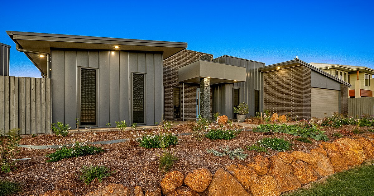Dark house facade with elevated garden in front