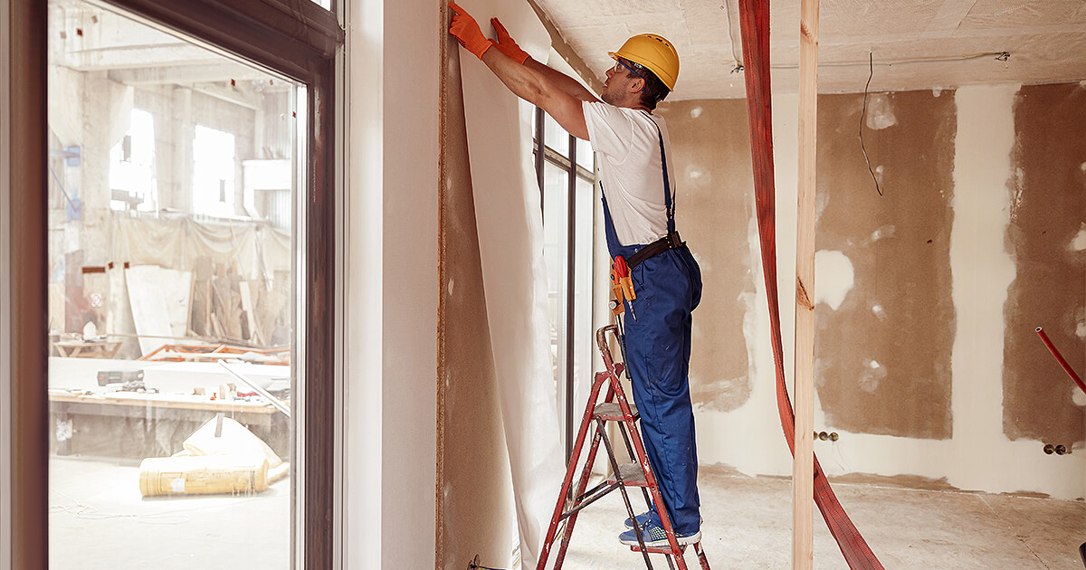 Building sticking up wallpaper during construction on room