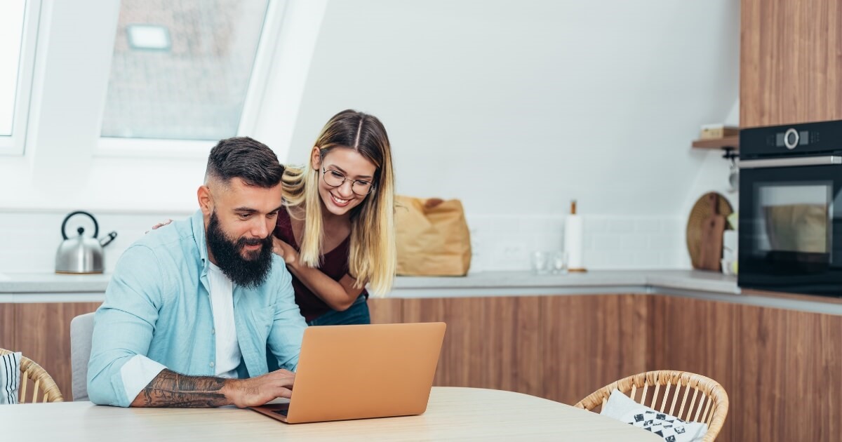 Man and woman looking at a computer researching building grants