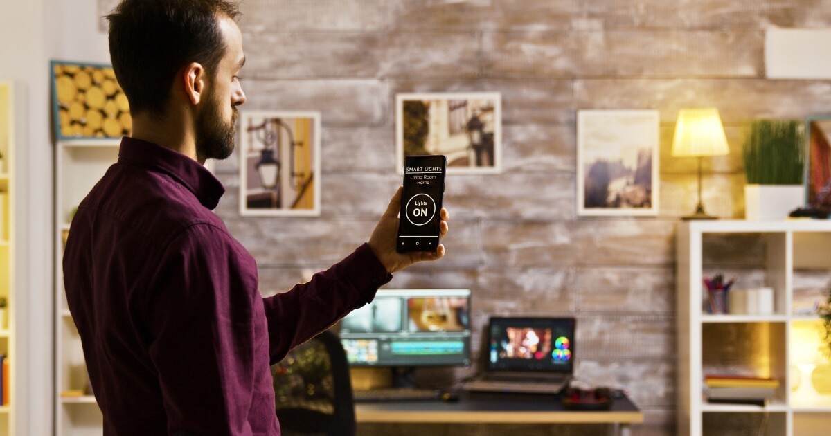 Man using smart technology to control lights in his house