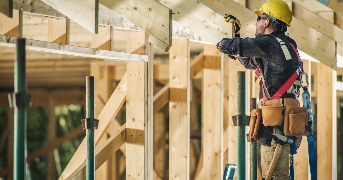 Construction worker working on the frame of a house