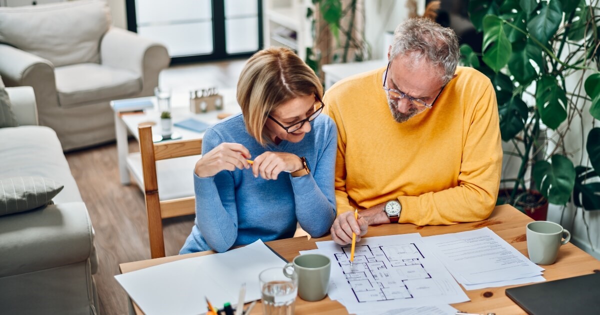 Couple planning the build a new home and looking at blueprints