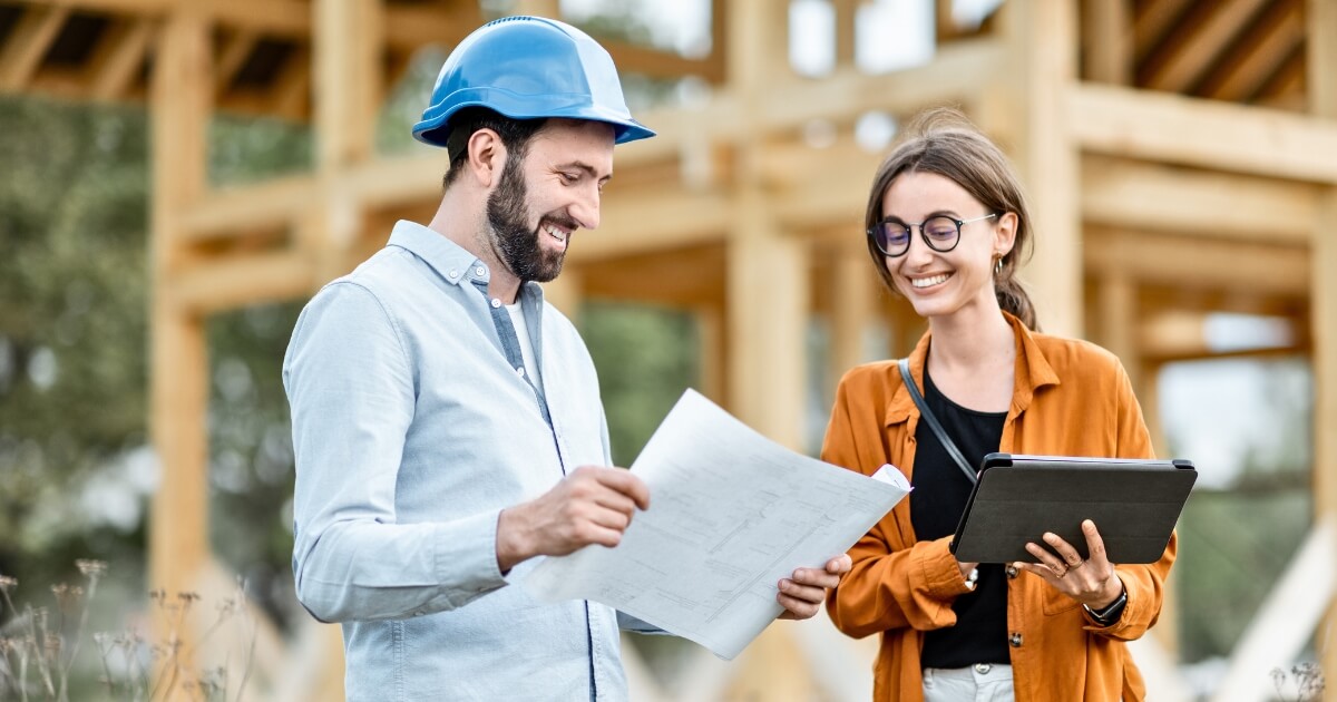 Builder speaking with new home building client on job site