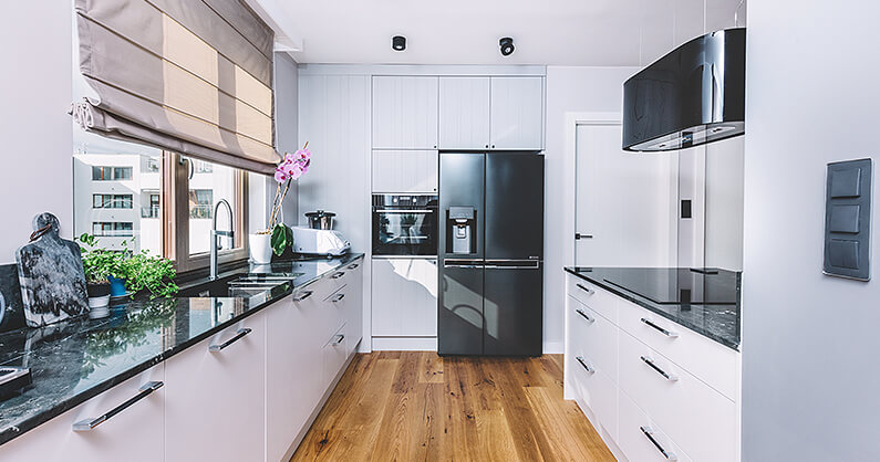 Galley style kitchen in white and black