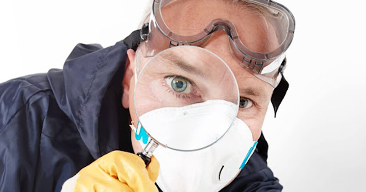 Man looking through magnifiying glass