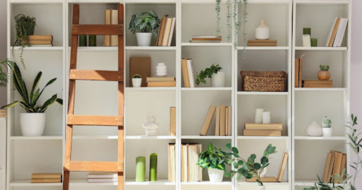 home library with floor to ceiling shelves and ladder